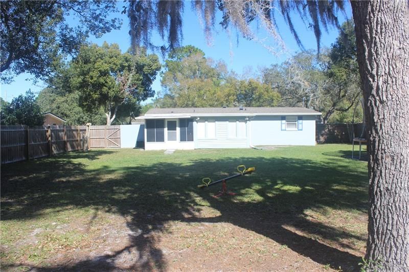 Plenty of Room To add a Pool.  Large Concrete Pad to your Right of Photo.  Sun and Shade in Backyard.