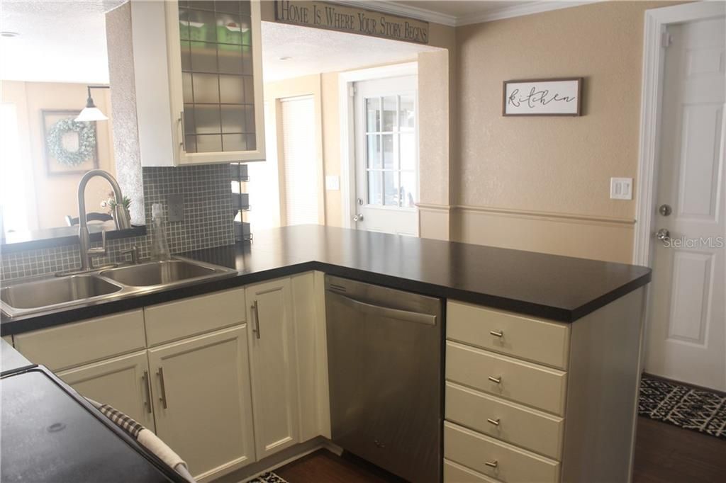 Lots of Kitchen Storage.  More Storage on other side of counter space.   Door leads to garage.  Door in Dining Room leads to Porch.