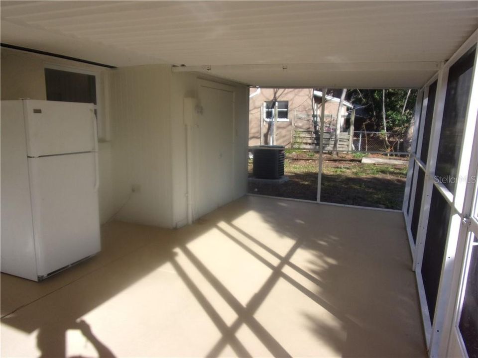 FLORIDA ROOM /LANAI LOOKING SOUTH  WITH STORAGE ROOM