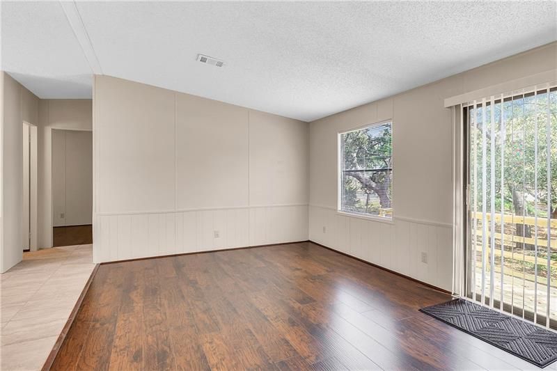 LIVING ROOM FEATURES GLASS SLIDING DOOR ON TO DECK