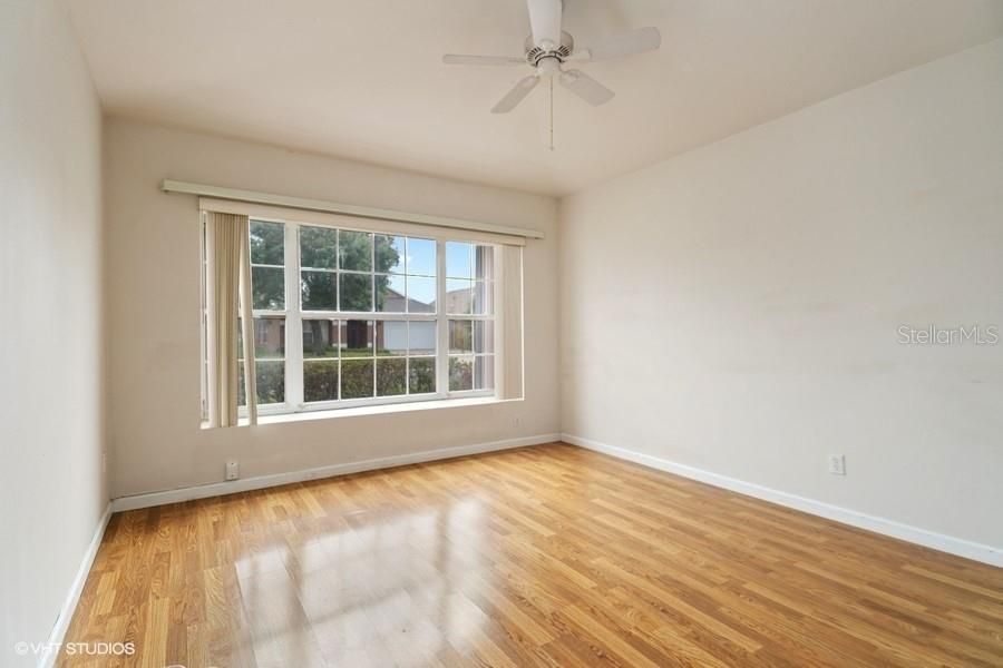 Second bedroom located at the front of the home with garden view