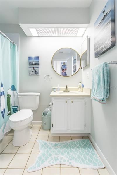 The guest bathroom is accessible from both the guest bedroom & the hallway.