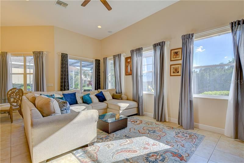 Family Room with water views and opens to screened lanai and pool area