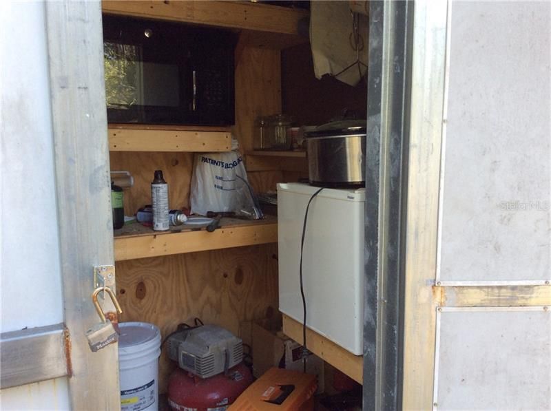 A few added comforts. Fridge, Microwave and flushing toilet in back.