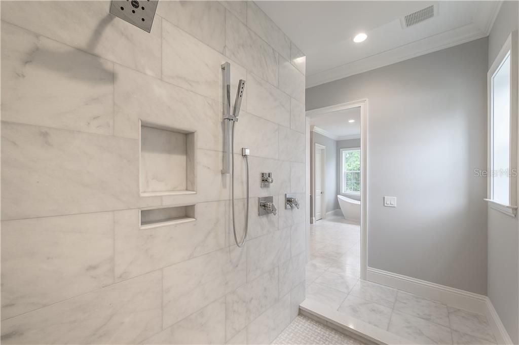 Grand primary shower, marble with multiple shower heads