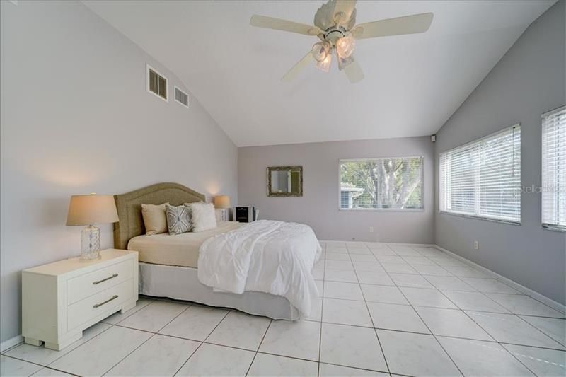 Spacious master bedroom with vaulted ceiling and outstanding private view of the back~