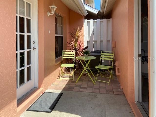 Quaint sitting porch between front door (left) and rear garage entry