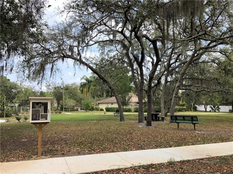 Nearby Park with Little Library, picnic tables, benches and walking trails.