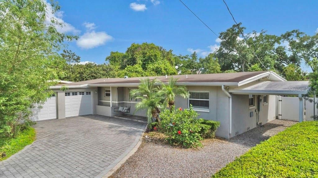 Exterior Front with Double Garage and Additional Covered Carport.