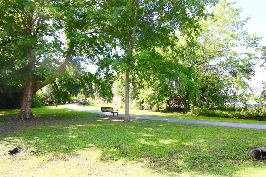 Bench along walkway of Lake Maude Park