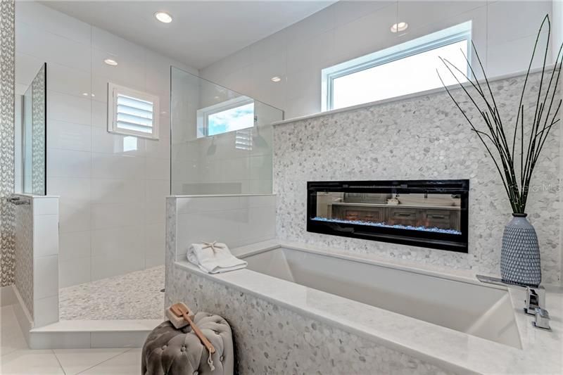 Walk-in shower, soaking tub with fireplace for an amazing ambiance