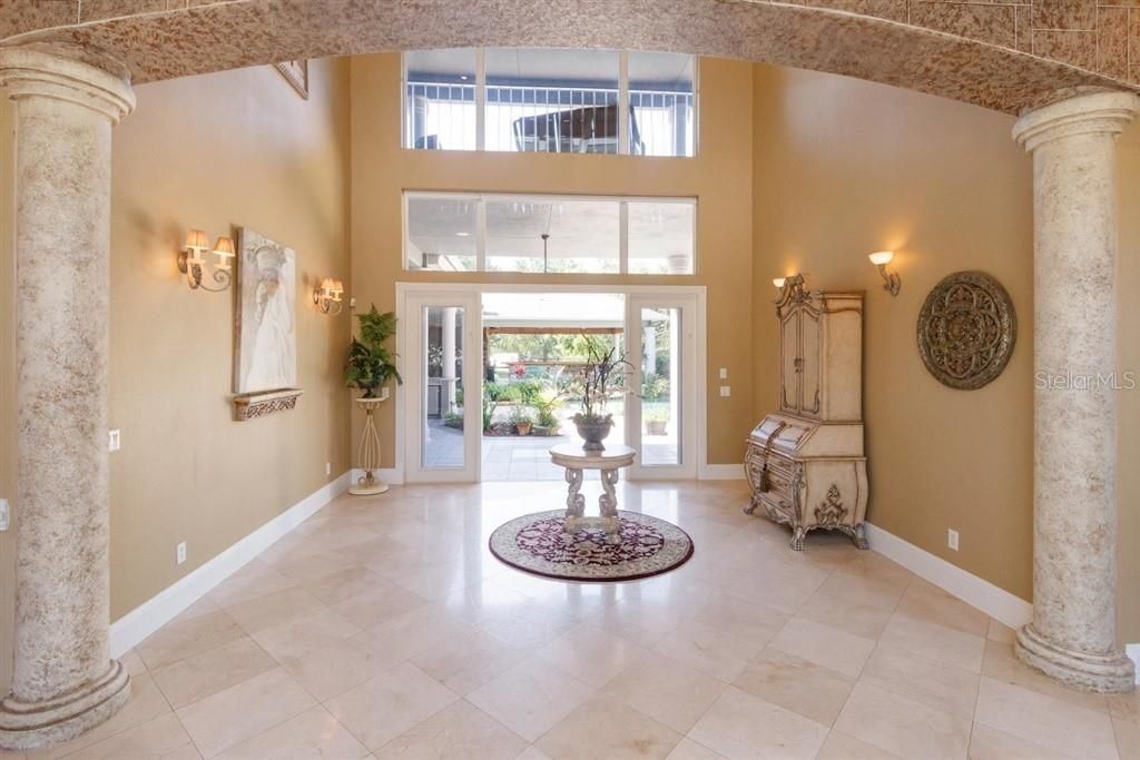 Foyer & Marble Floors leading out to Tropical Pool & Waterfalls