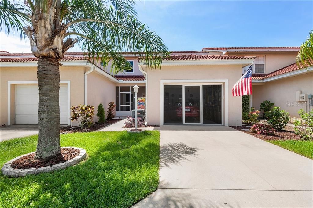 Screened Front Porch and retractable garage screen. Tile roof.