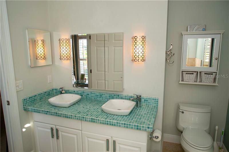 Dual sinks in master with exquisite tile counters.