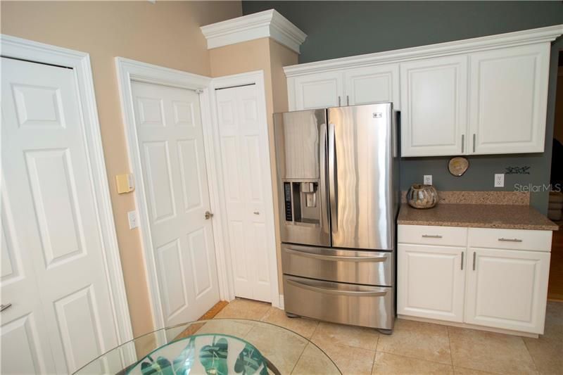 Additional view of kitchen with beautiful cabinetry and stainless appliances.