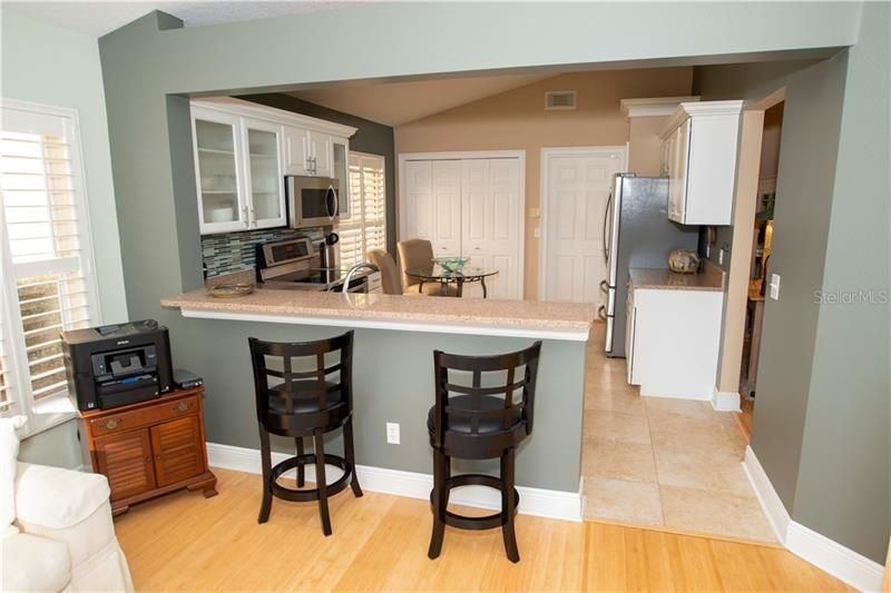Breakfast bar between family room and kitchen.