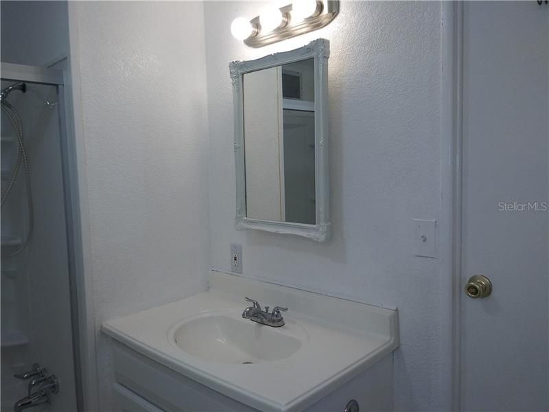 New light fixture above sink.  Door leads to 2nd bedroom