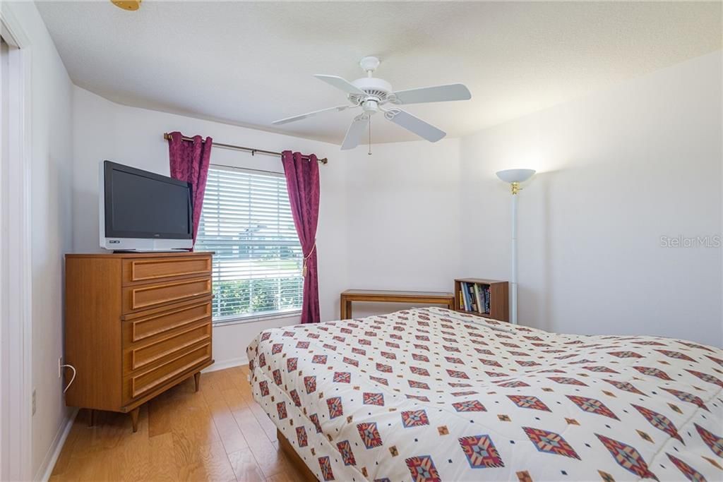 GUEST BEDROOM WITH WOOD FLOORS.