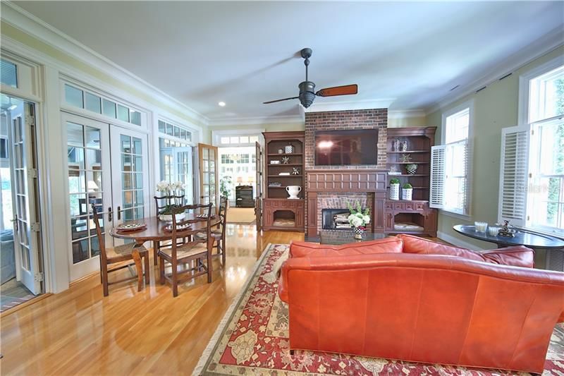 Open Kitchen leads to Informal Living/Dining Area with Fireplace