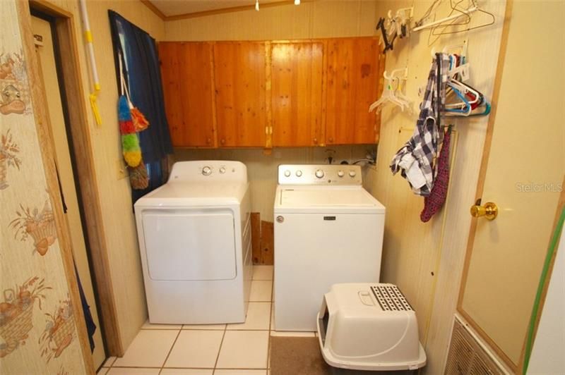 laundry room with built in upper cabinets