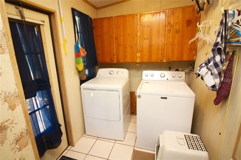 Laundry room with door exiting to back yard
