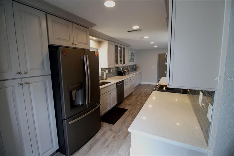 NEW Kitchen with Smoke Stainless Appliances, Quartz Countertops, Soft Close Wood Cabinets and Dimmer Recessed Lighting