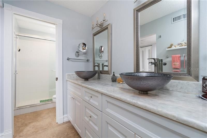 The master ensuite has been completely renovated with new cabinetry and stylish bowl sinks.