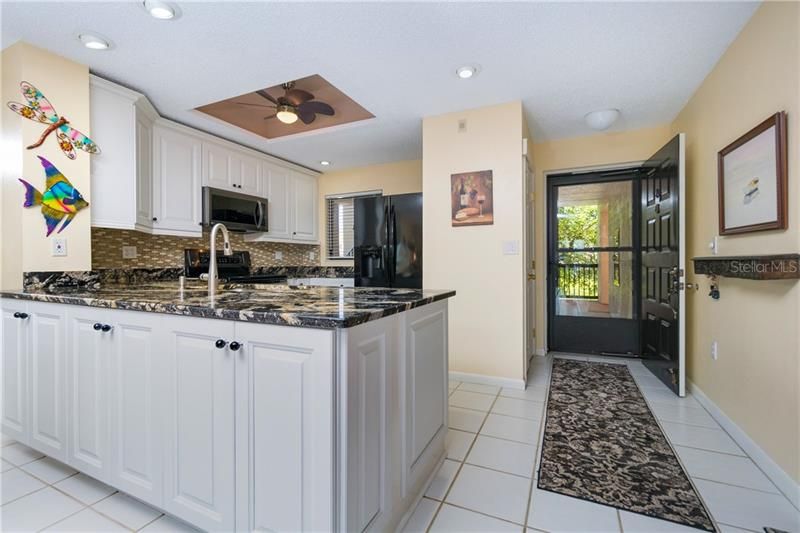 As you enter the newly renovated kitchen is to your right. Stunning granite counters and abundant storage.