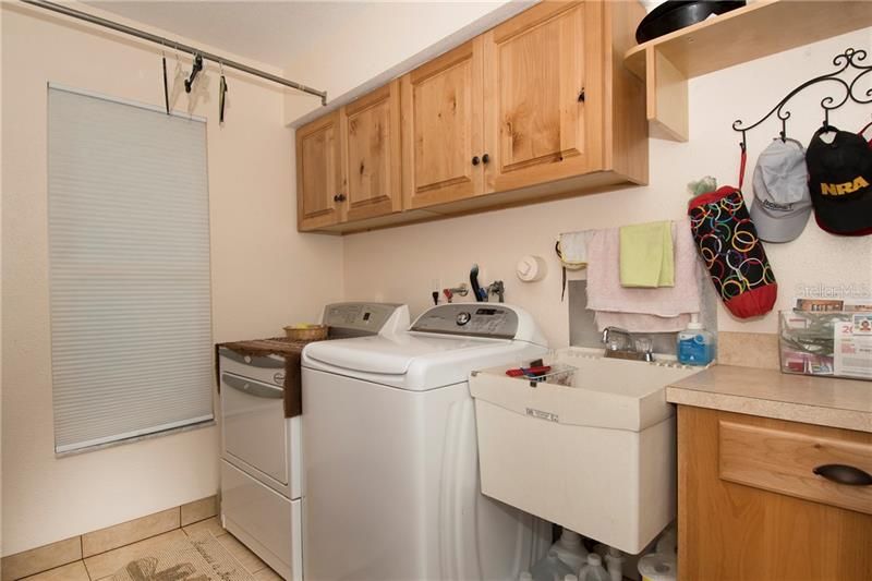 Laundry room with new cabinets and sink.