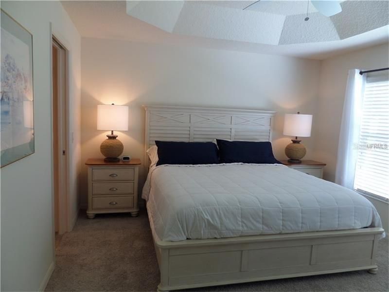 This Master bedroom offers King Size bed, coffered ceilings, carpet flooring and LARGE walk-in closet.