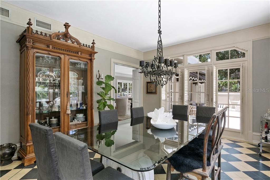 Dining room has two sets of French doors that opens out to the patio with fire pit and to the pool