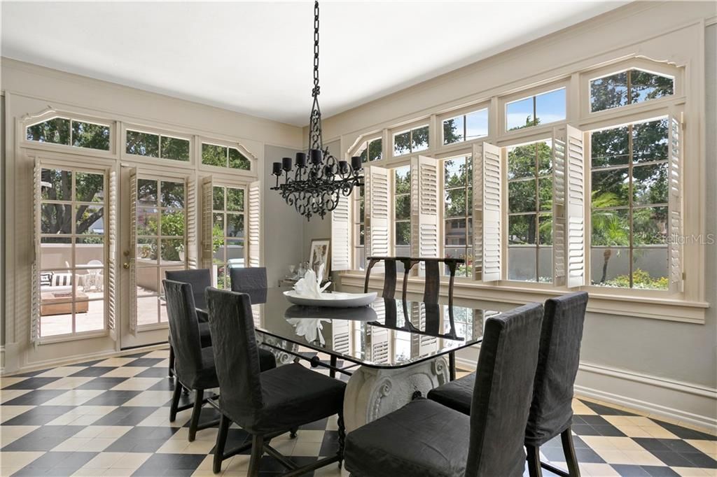 Stunning formal dining room with original tile, high ceilings and tons of natural light