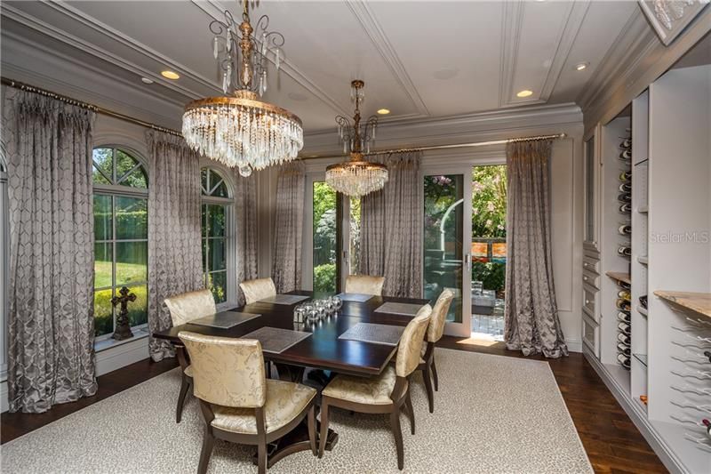 Formal Dining Room - with custom draperies, wood floors and twin chandeliers ! Beautiful !