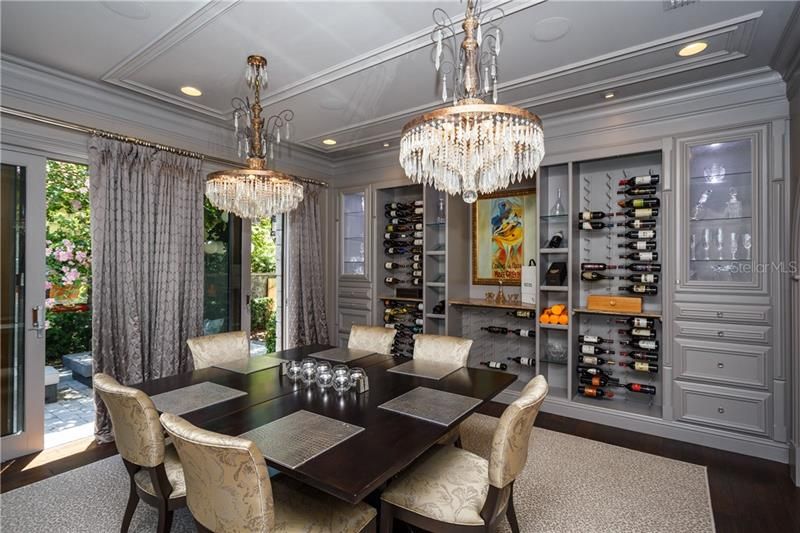Formal Dining Area with  Wine storage wall and glass doors opening to intimate courtyard