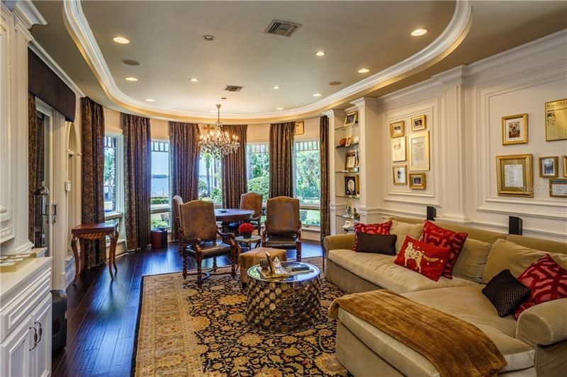 The Entertainment Room/Family room boasts lakefront views and exquisite wall moldings, large screen TV