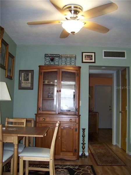 You're in the kitchen, looking back towards the dining area. You can see the bedroom in the back.