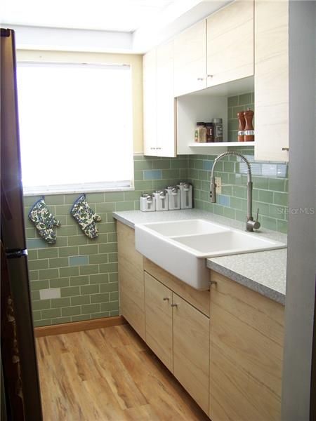 Kitchen updated in 2019: cabinets, sink, faucet, plumbing, appliances, counter-top, back splash and flooring continues here, too.