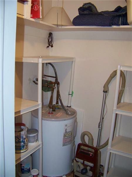 Walk-in closet. I'm sure you've noticed the ample storage by now. The flooring has been continued into here, as well.