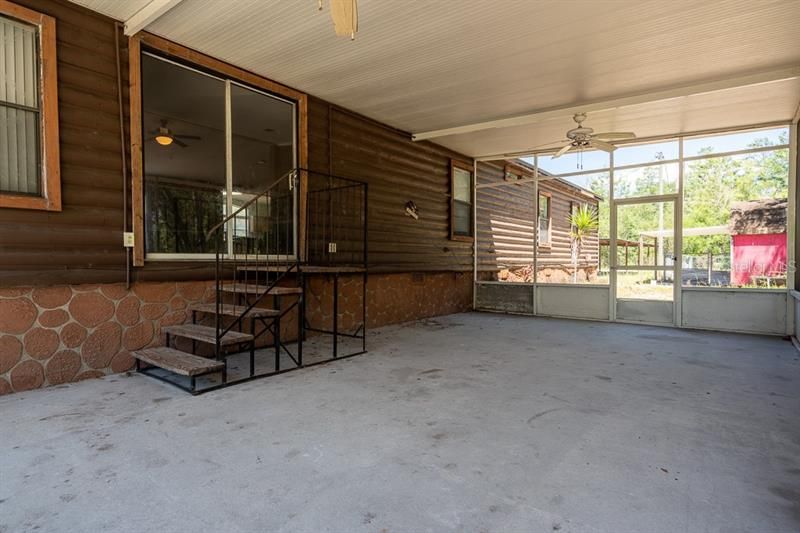 Huge rear screened porch. Doors lead to main living area with fireplace.