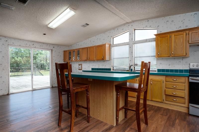 Huge kitchen with volume ceilings and an abundance of natural lighting. Doors to huge front porch.