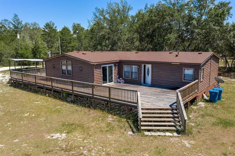 5/3 log manufactured home with new roof on 5 high and dry fenced acres.