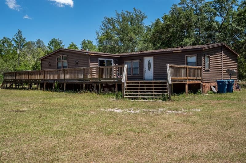5/3 log manufactured home with new roof on 5 high and dry fenced acres.