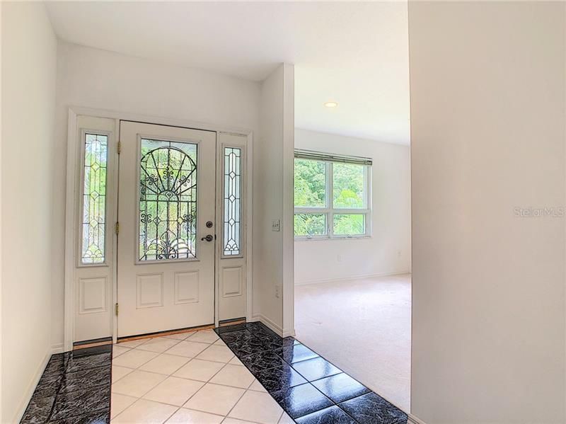 Beautiful decorative glass entry door and side windows add natural light and beauty. Coat closet located in foyer.