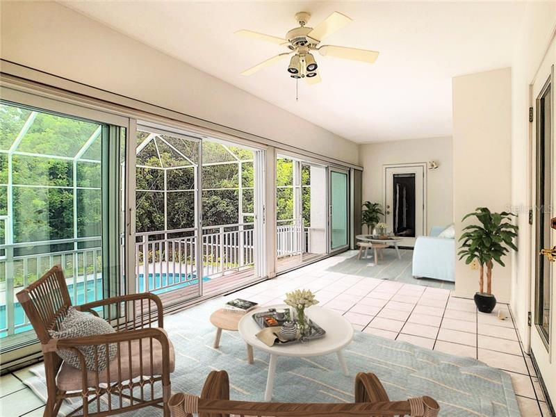 Relaxing Florida Room with expanse of newer hurricane sliders leading to composite decking and steps to your pool. Doors to full bath & guest bedroom hallway, master bedroom and great room.