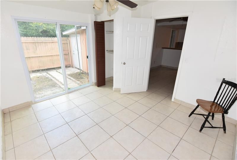 Rear guestroom with sliding doors to private fenced courtyard