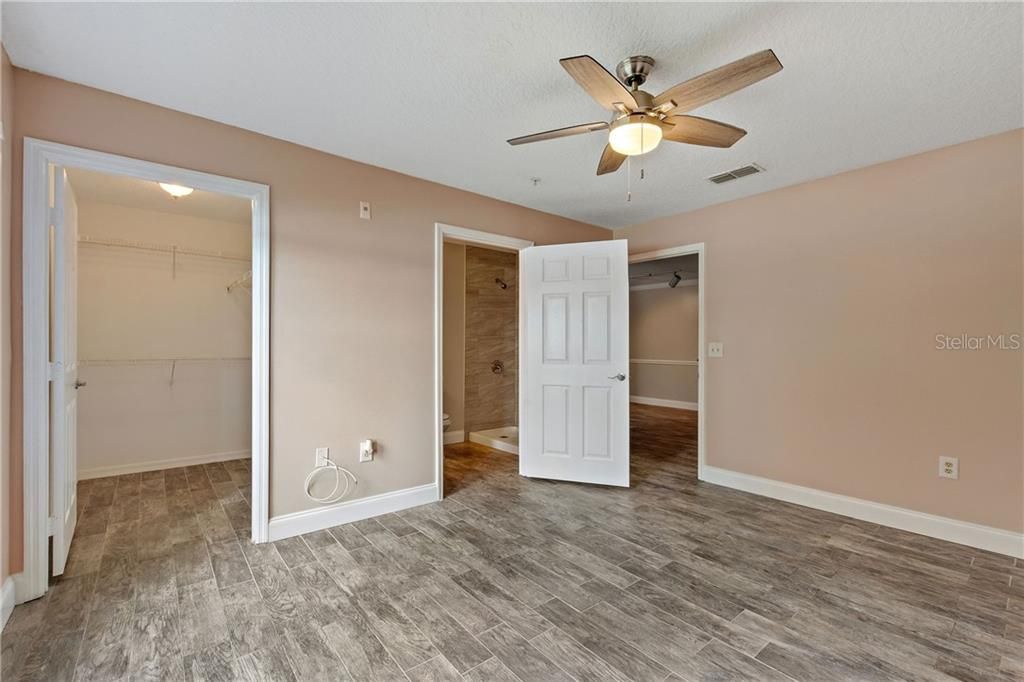 Master suite with oversize walk-in closet and water view