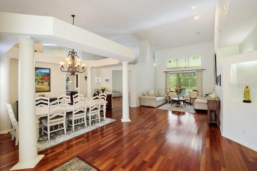 View from foyer through to living room with sliders to covered pool patio.