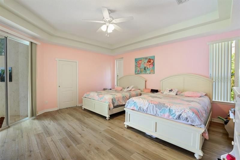 Master bedroom with sliders to pool patio and master bath.