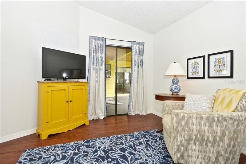 Master Bedroom with sliding glass doors opening out to screened porch.