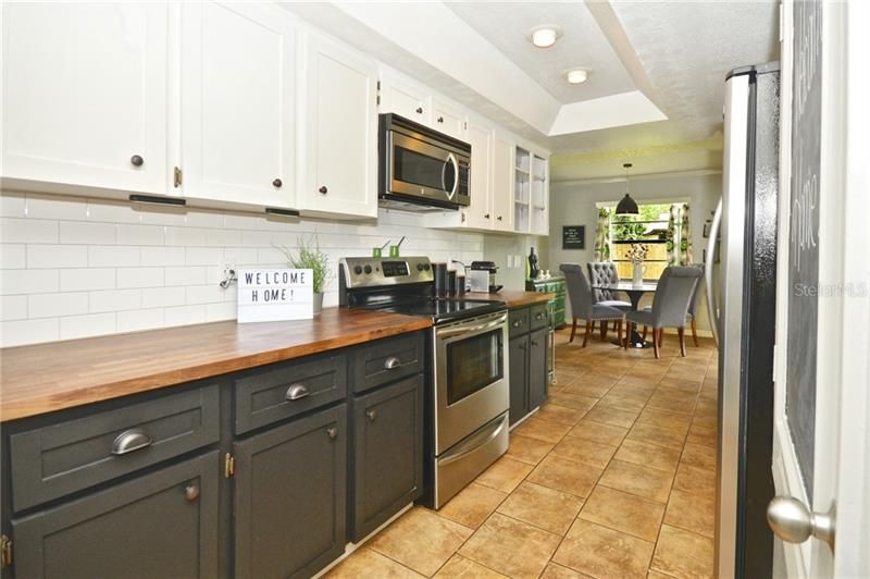 Galley kitchen with tile flooring.